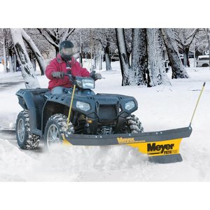 A homeowner plows his driveway with a plow attached to an ATV.