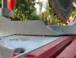 A miter saw sits dusty shortly after a cut.
