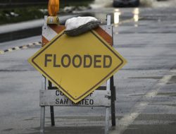 Flooded sign blocking off roadway