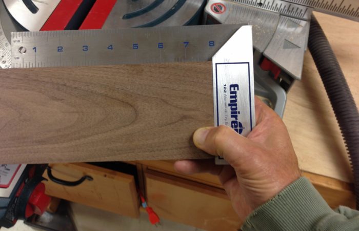Check for a square cut on your miter saw or table saw with a tri-square after you have moved your tools