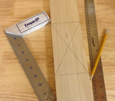 Find the center of a board with an Empire Square and Ruler.