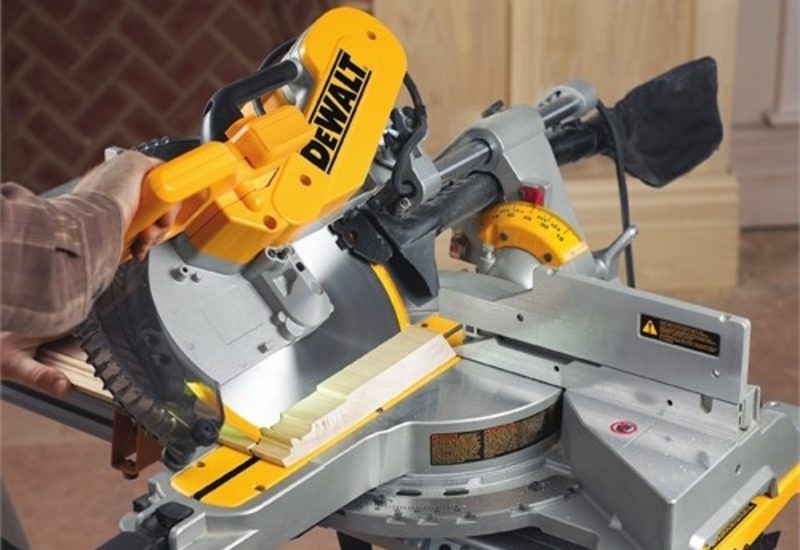 miter saw cutting wood giving reader an example of how to best cut crown molding