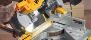 miter saw cutting wood giving reader an example of how to best cut crown molding