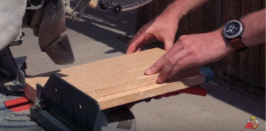 Raising the material on your miter saw to increase the cut capacity.
