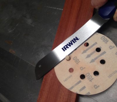 Use an old sanding disc to prevent saw tooth marks when cutting a plug from a project.