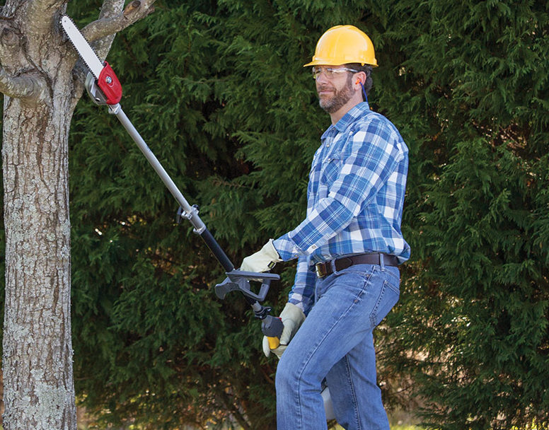 Man using a Honda power head saw attachment