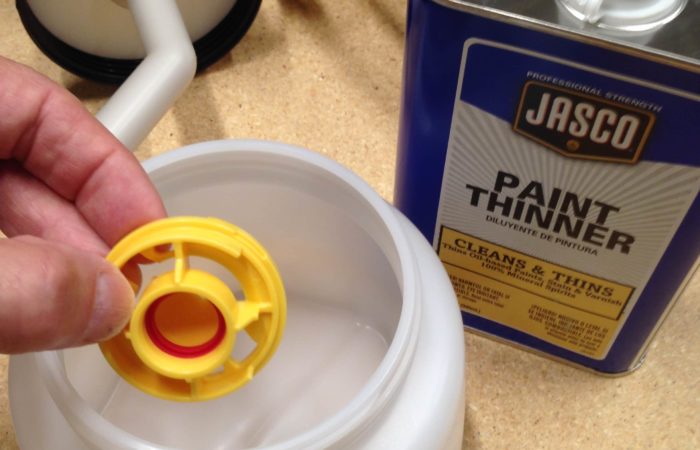 Add paint thinner or water to your paint sprayer cup and drop your tips in it to keep them clean
