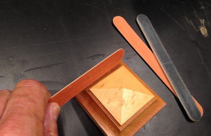 Use an emory board to sand delicate objects and small areas.