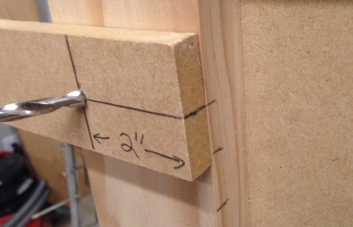 When drilling repetitive holes, make a jig like the one shown. Take a piece of scrap wood and strategically place your hole in it and add a spacer to the back if needed. This will save you all kinds of time.