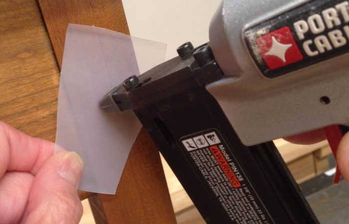 To prevent a dent on your work when using a nail gun shoot the nail through a thin piece of plastic.