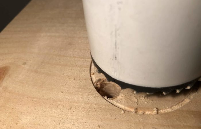 When drilling with a hole saw use a relief cut made by a standard drill bit to allow shavings to fall into thus cleaning the hole you are cutting out.