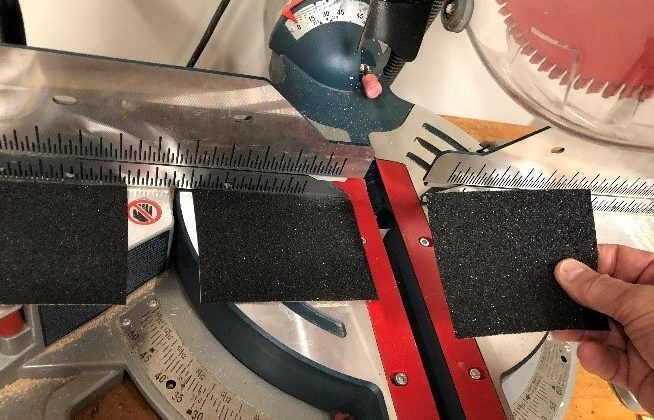 Adding sandpaper to the table of your miter saw can help when cutting crown molding.
