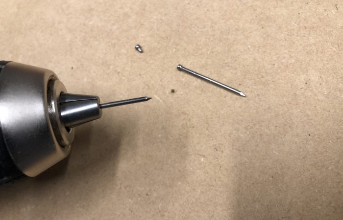use a nail to drill a clean hole if you don't have a drill bit around