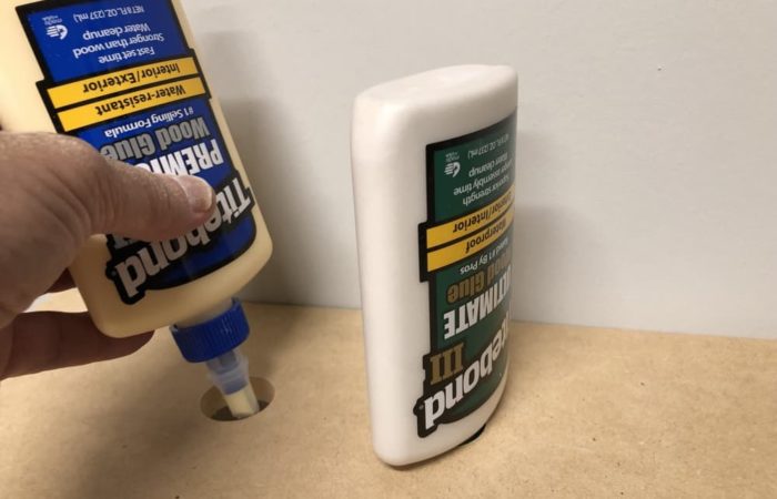 To store glue bottles upside down drill a 1 inch hole in your shelf and insert the tip through the hole.