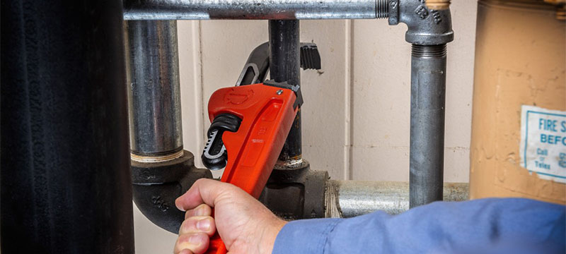 Contractor using a Crescent Pipe Wrench Grip tool