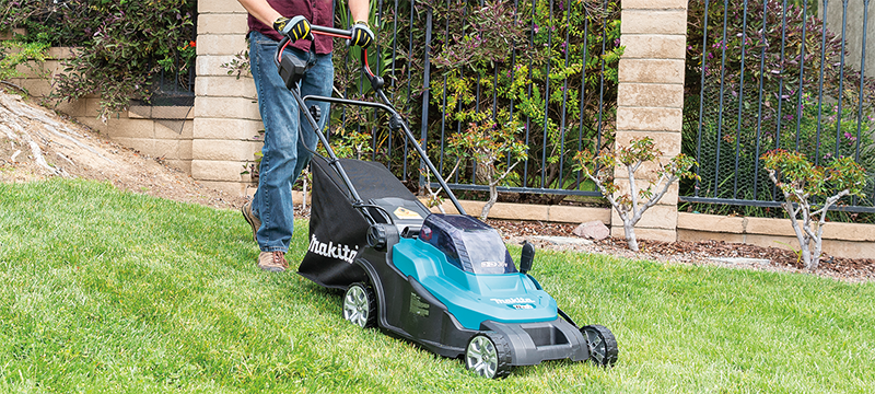 Home owner using Makita cordless lawn mower from the landscaping equipment collection.