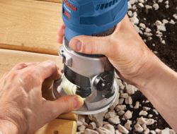A homeowner uses Bosch Colt Variable-Speed Palm Router on the edges of their deck.
