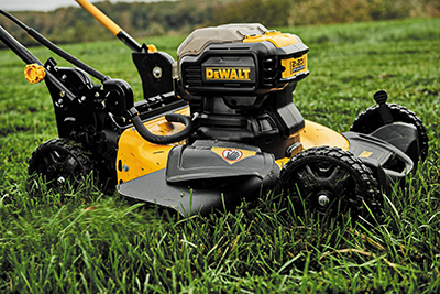 DEWALT 2x20 Volt MAX Push Mower cuts through grass on a lawn.