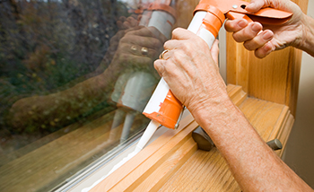 Caulk is used to insulate a window.