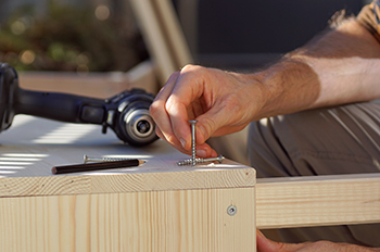 Two sides of a frame are secured together using screws.