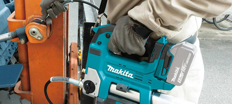Makita 18V LXT Cordless Grease Gun is used to grease a fitting.