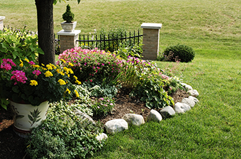 Natural rock edging can be a very cheap and beautiful way to spruce up your flower bed.