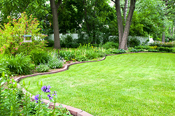 Pavers are used are decoratively placed as edging around a flower bed.