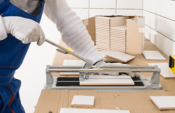 A snap cutter is used to score tile before it's snap in half.