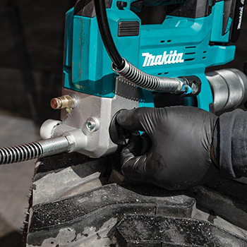 The speed selector switch on the Makita 18V LXT Grease Gun is adjusted.