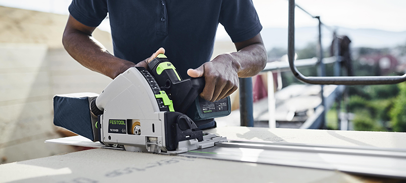 The Festool 55K KEB Track Saw is used to cut a piece of material.