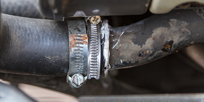 A hose clamp connecting two hoses on a motor.