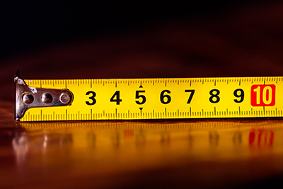 A metric tape measure sit extended on a table.