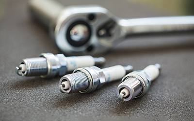 Spark plugs sitting on a table.