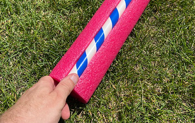 A pink pool noodle is wrapped around a portion of the PVC pipe.