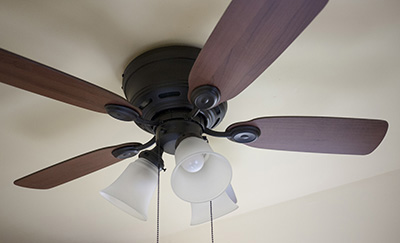 A ceiling fan sits idle in a room.