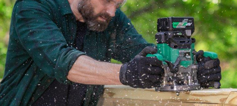 The Metabo HPT 36V Cordless Plunge Router is used to work on a deck railing.