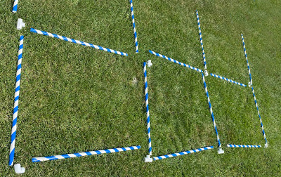 Taped PVC pipe laid out on the ground in a design.