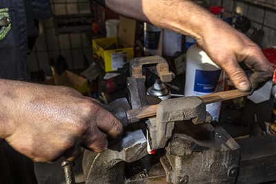 A file is used to remove rust from a tool.