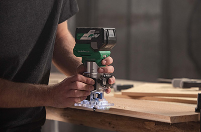 Metabo HPT's 18V Cordless Brushless Trim Router is used to create a rounded edge on a 1 by 10-inch piece of wood.