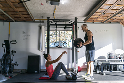 A portion of a garage is used as a gym.