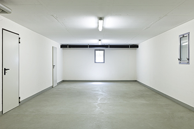 An empty garage with fluorescent lighting.