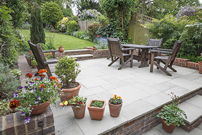 Plants sit in planters around a patio.