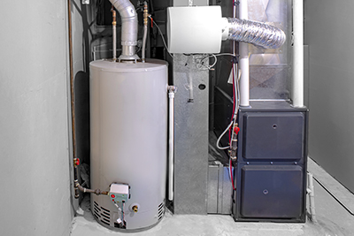 A gas water heater sits in the basement of a home.
