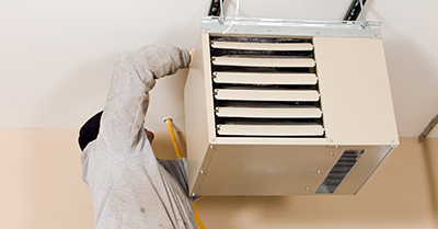 A heater being installed in a garage.