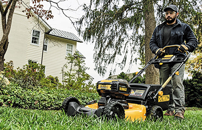 A DEWALT lawn mower is used to cut grass.