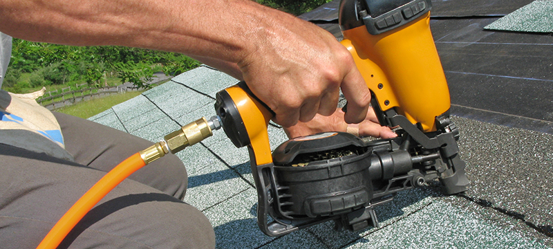 A roofing nailer is used to attach shingles to a home.