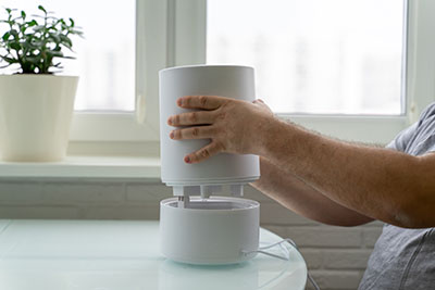 using a humidifier at home. a man disassembles a cleaning device