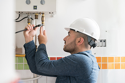 A professional installs a new water heater.