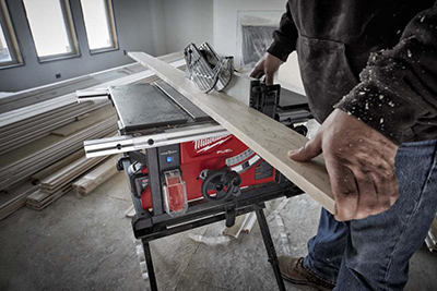 A board is ripped on a Milwaukee M18 FUEL 8-1/4 inch Table Saw