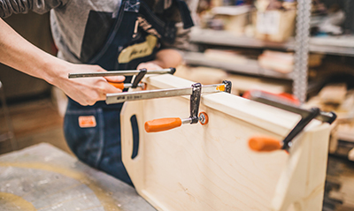 Several clamps holding a woodworking project together.